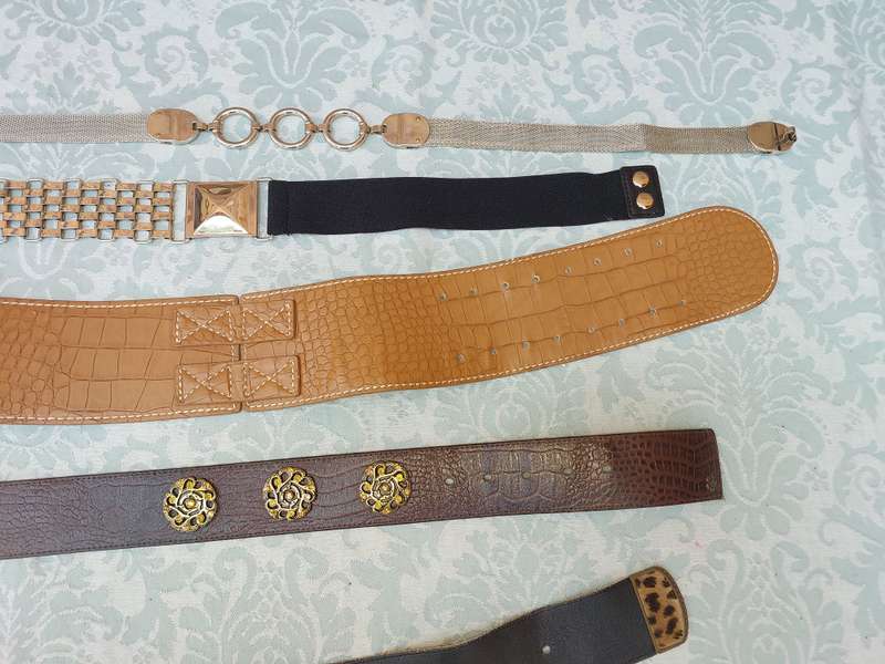 A COLLECTION OF FASHION WOMANS BELTS SOLD AS IS