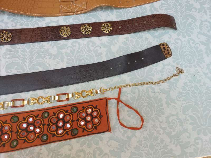 A COLLECTION OF FASHION WOMANS BELTS SOLD AS IS