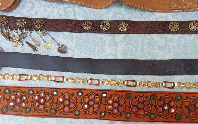 A COLLECTION OF FASHION WOMANS BELTS SOLD AS IS