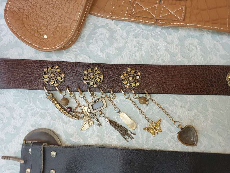 A COLLECTION OF FASHION WOMANS BELTS SOLD AS IS
