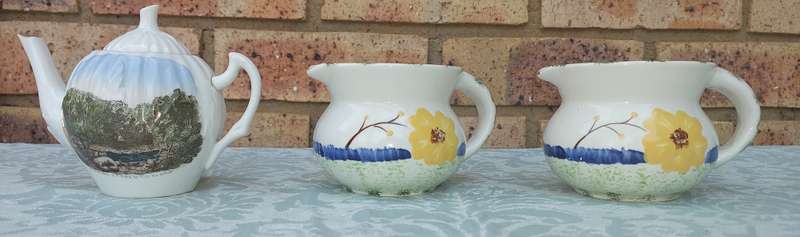 A COLLECTION OF 3 VINTAGE PORCELAIN JUGS SOLD AS IS