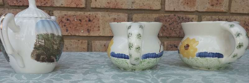 A COLLECTION OF 3 VINTAGE PORCELAIN JUGS SOLD AS IS