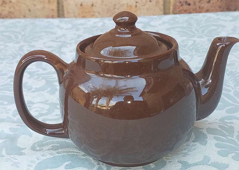 A vintage ceramic brown teapot sold as is
