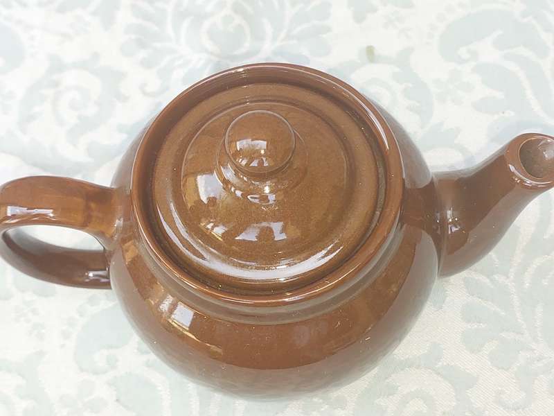 A vintage ceramic brown teapot sold as is