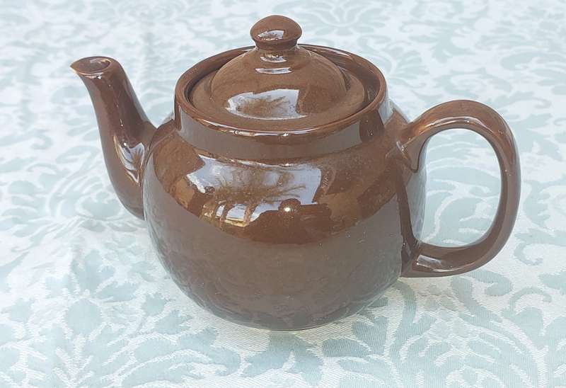 A vintage ceramic brown teapot sold as is
