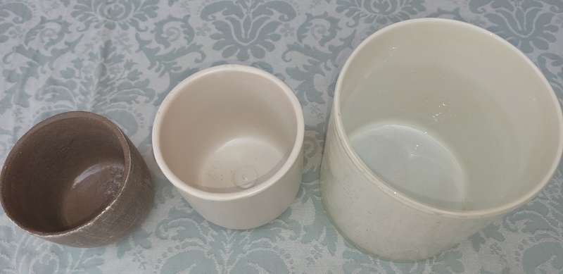 TWO CERAMIC POTS AND A GLASS FLOWER POT SOLD AS IS