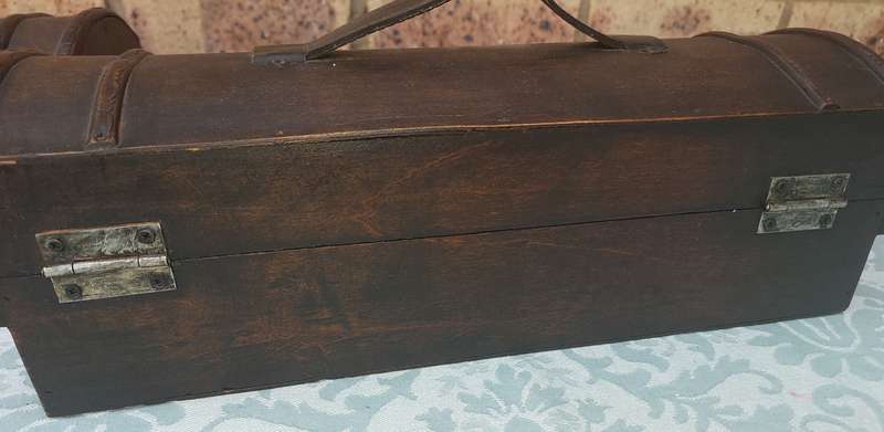TWO ORNATE WOODEN WINE CADDYS WITH LEATHER HANDLES
