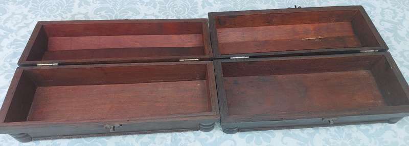 TWO ORNATE WOODEN WINE CADDYS WITH LEATHER HANDLES