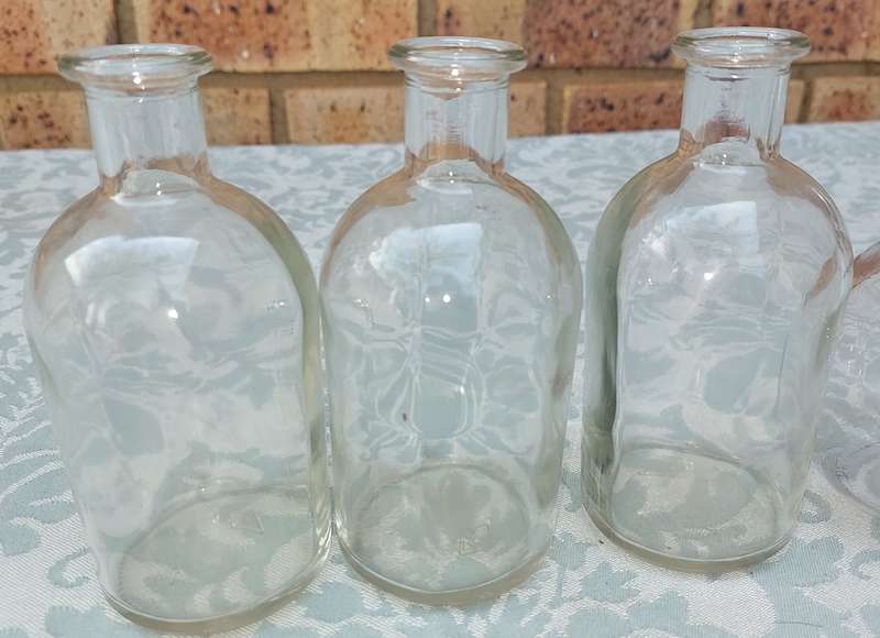 A COLLECTION OF GLASS SAUCE BOTTLES SOLD AS IS