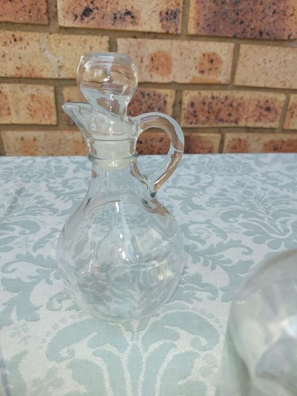 A COLLECTION OF GLASS SAUCE BOTTLES SOLD AS IS