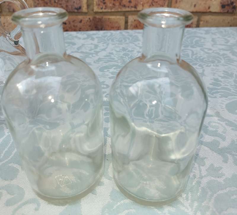 A COLLECTION OF GLASS SAUCE BOTTLES SOLD AS IS