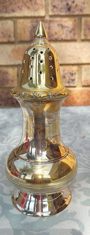 A VINTAGE SILVERPLATE ON BRONZE SUGAR SIFTER
