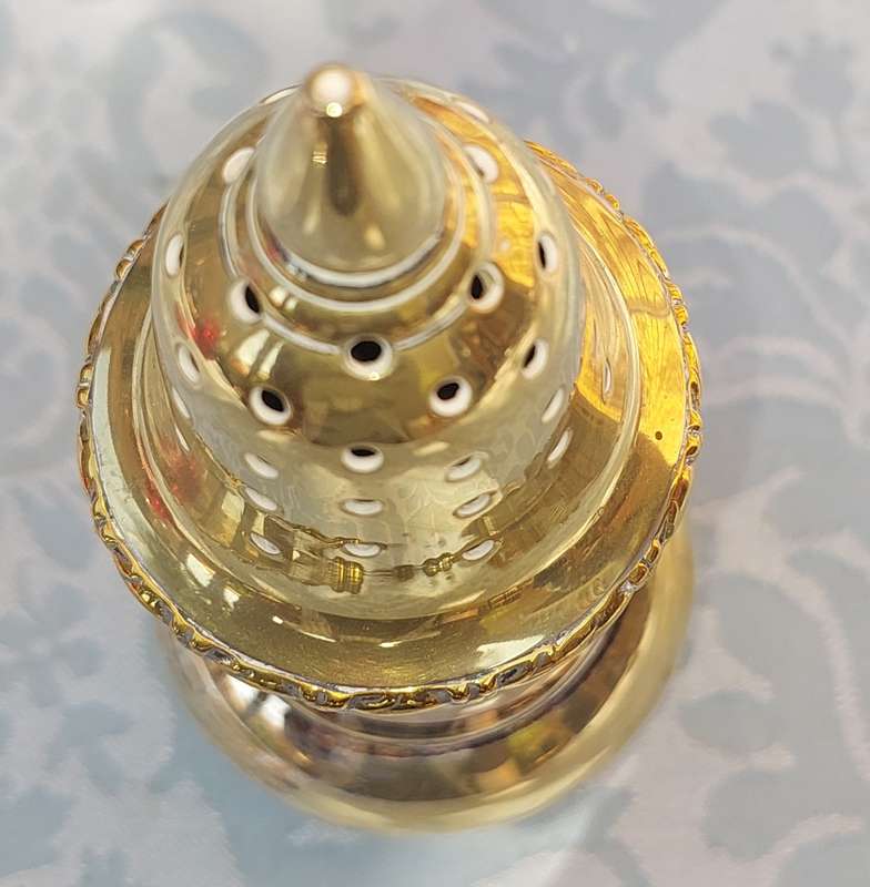 A VINTAGE SILVERPLATE ON BRONZE SUGAR SIFTER
