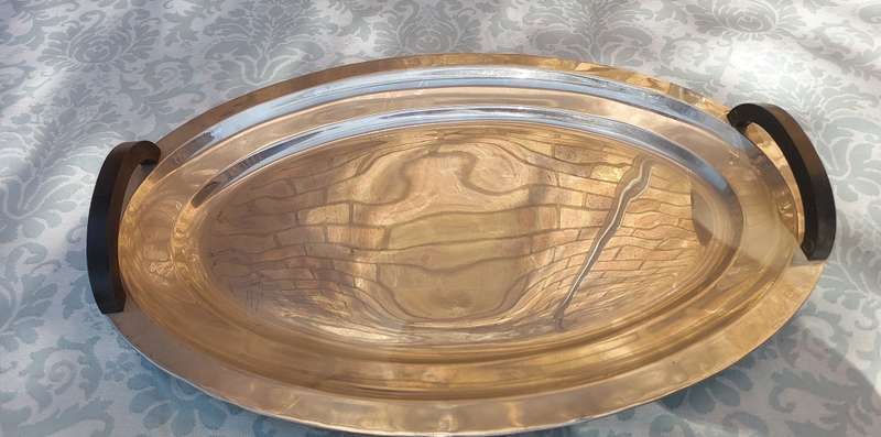 AN OVAL ELEGANT STAINLESS STEEL SERVING TRAY WITH WOODEN HANDLES