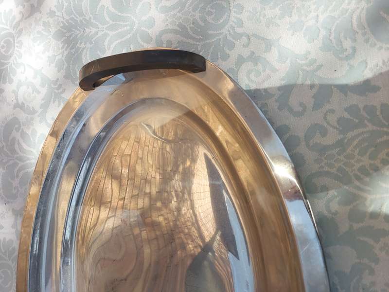 AN OVAL ELEGANT STAINLESS STEEL SERVING TRAY WITH WOODEN HANDLES