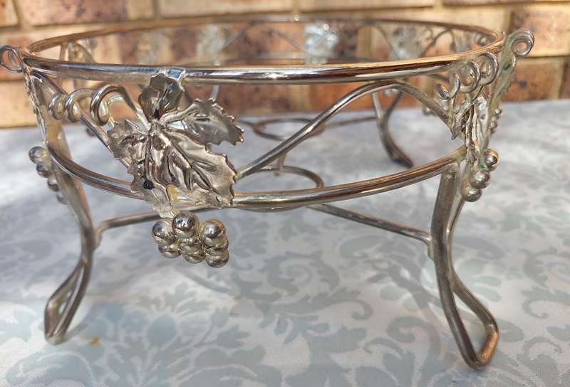 A VINTAGE GRAPEVINE CASSEROLE WARMER STAND