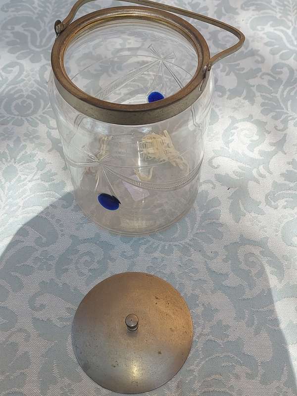A VINTAGE CUT GLASS ICE BUCKET WITH A SILVER PLATED LID AND HANDLE