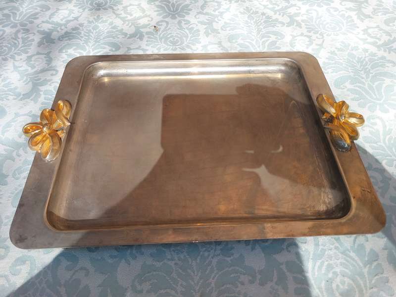 A RECTANGULAR STAINLESS STEEL WITH GOLDPLATED BOW HANDLES