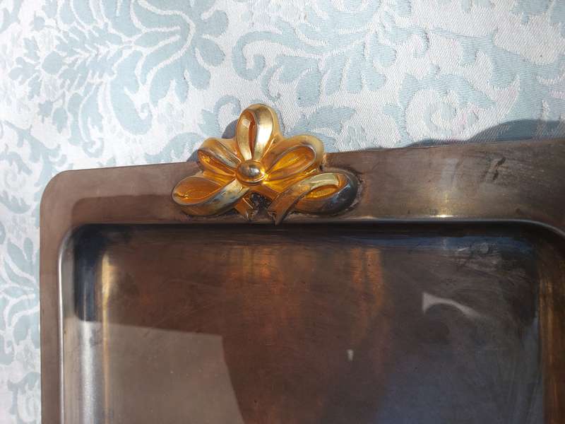 A RECTANGULAR STAINLESS STEEL WITH GOLDPLATED BOW HANDLES