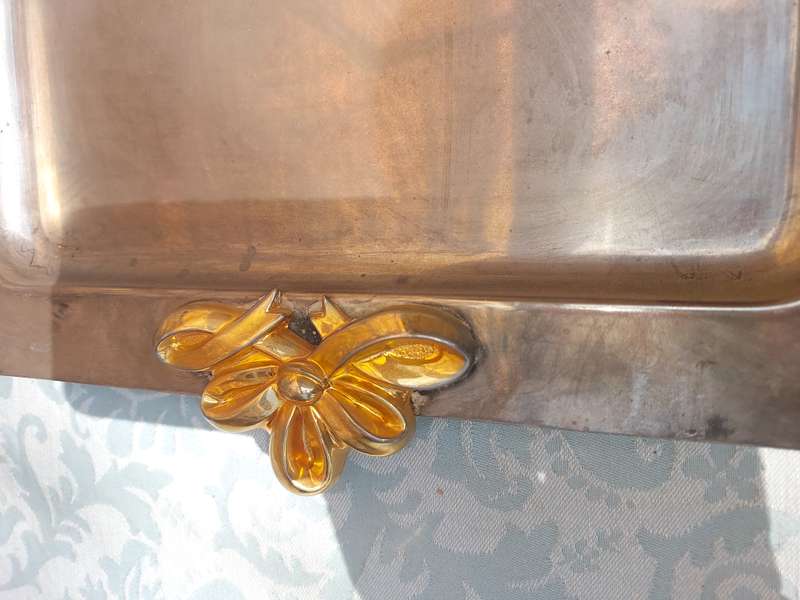 A RECTANGULAR STAINLESS STEEL WITH GOLDPLATED BOW HANDLES