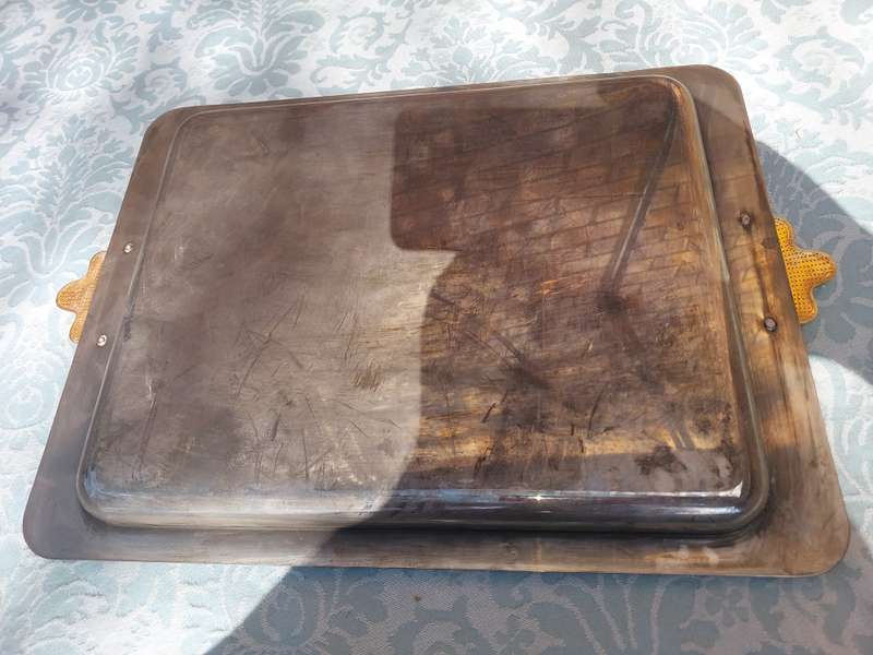 A RECTANGULAR STAINLESS STEEL WITH GOLDPLATED BOW HANDLES