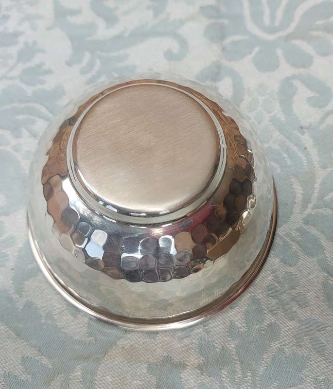 A STAINLESS STEEL BOWL CANDLE HOLDER