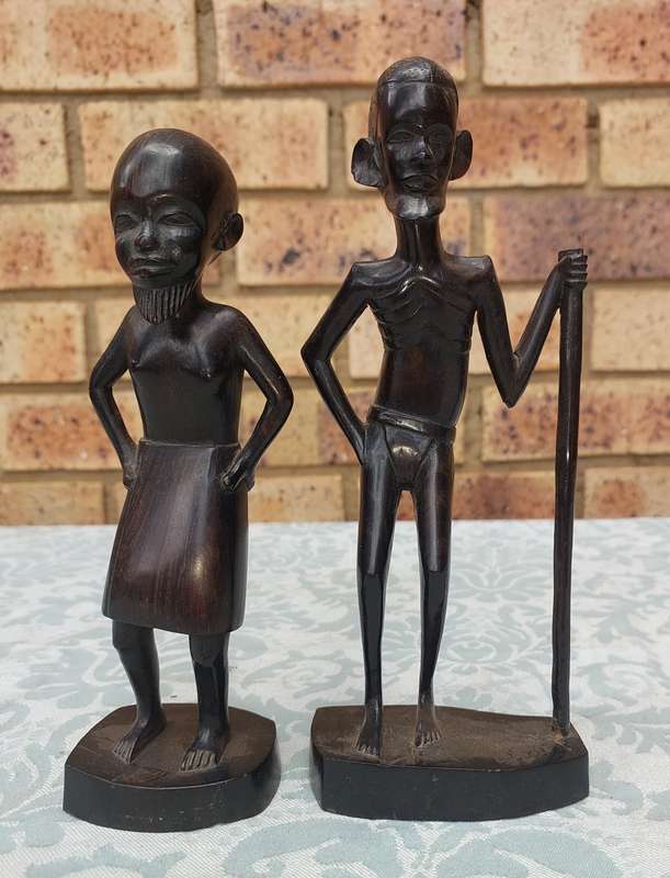 A PAIR OF VINTAGE HARD WOOD AFRICAN ART SCULPTURES SOLD AS IS