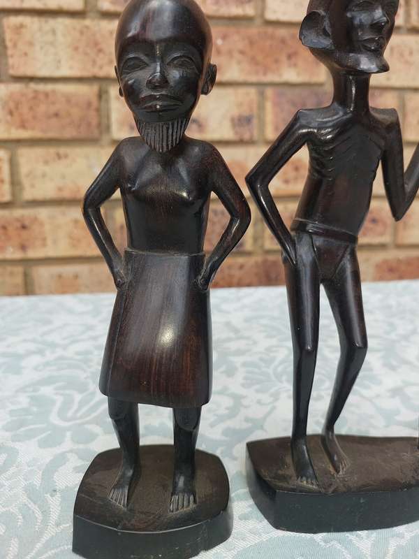 A PAIR OF VINTAGE HARD WOOD AFRICAN ART SCULPTURES SOLD AS IS