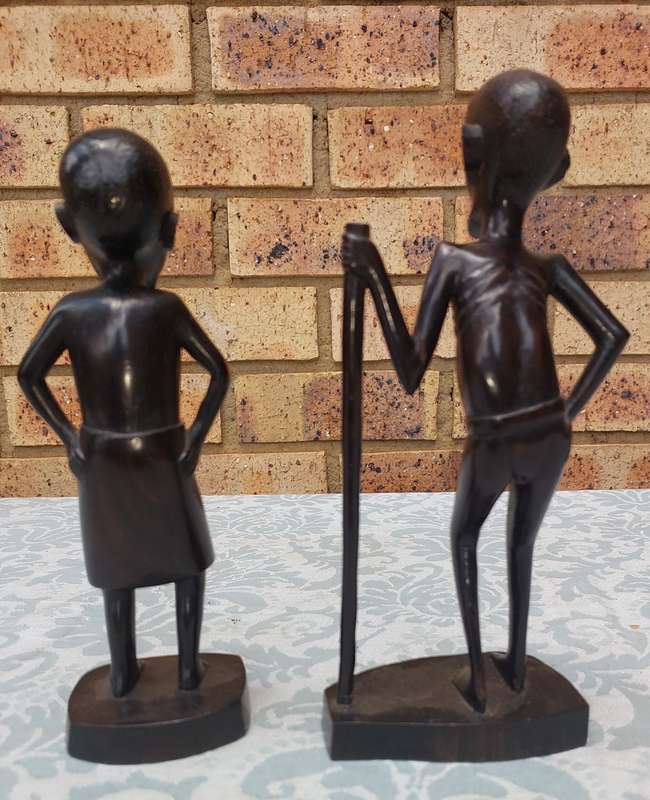 A PAIR OF VINTAGE HARD WOOD AFRICAN ART SCULPTURES SOLD AS IS