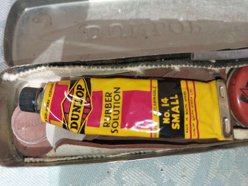 A VINTAGE BICYCLE PUNCTURE REPAIR KIT BY DUNLOP SOLD AS IS
