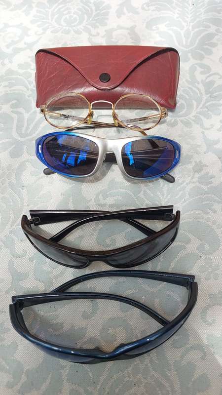 A COLLECTION OF SUNGLASSES AND AN ANTIQUE SPECTACLE SOLD AS IS