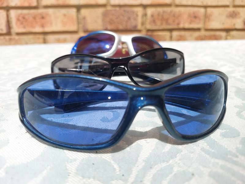 A COLLECTION OF SUNGLASSES AND AN ANTIQUE SPECTACLE SOLD AS IS