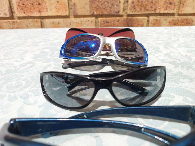 A COLLECTION OF SUNGLASSES AND AN ANTIQUE SPECTACLE SOLD AS IS