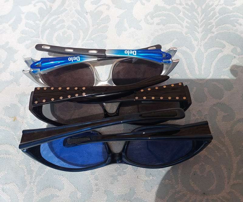 A COLLECTION OF SUNGLASSES AND AN ANTIQUE SPECTACLE SOLD AS IS