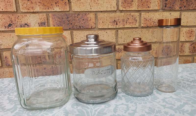 A COLLECTION OF GLASS STORAGE JARS SOLD AS IS