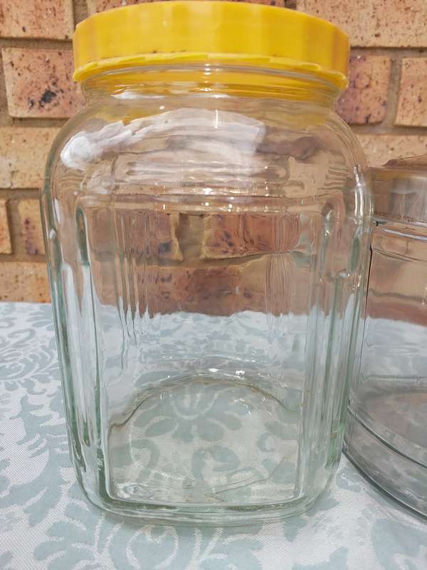 A COLLECTION OF GLASS STORAGE JARS SOLD AS IS