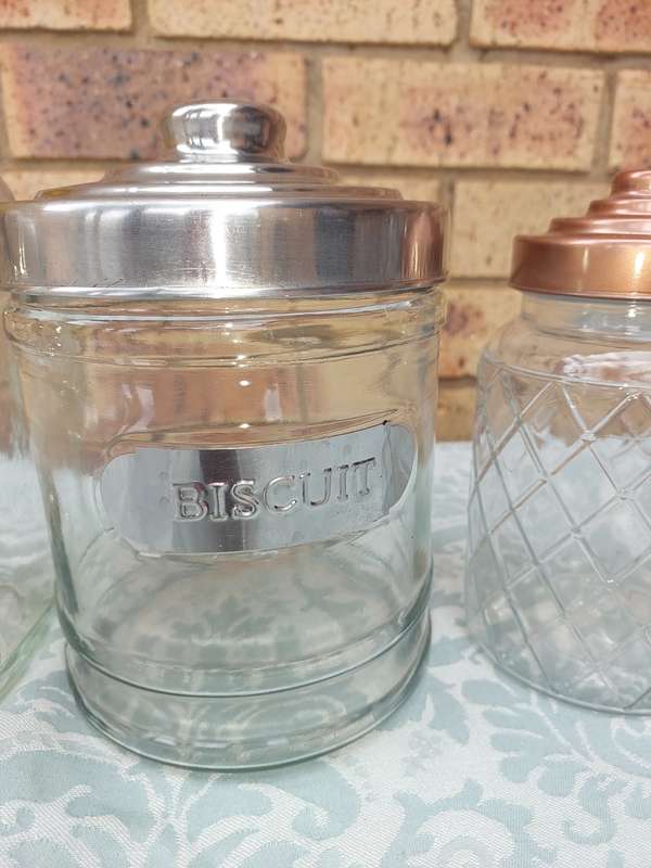 A COLLECTION OF GLASS STORAGE JARS SOLD AS IS
