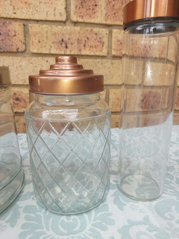 A COLLECTION OF GLASS STORAGE JARS SOLD AS IS