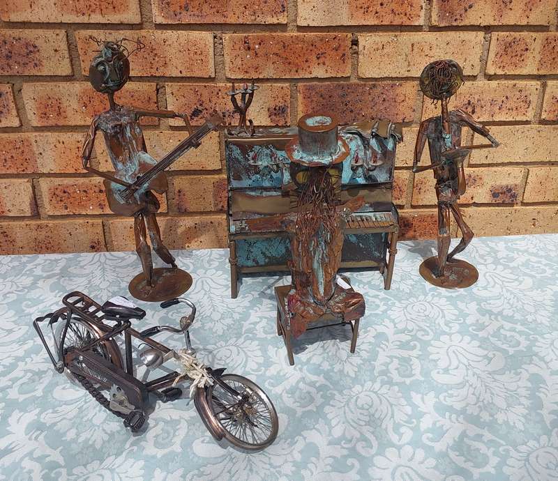 A COLLECTION OF COPPER FIGURINE ART SCULPTURES A PIANIST ,A PIANO WITH A SAXOPHONIST AND A BICYCLE