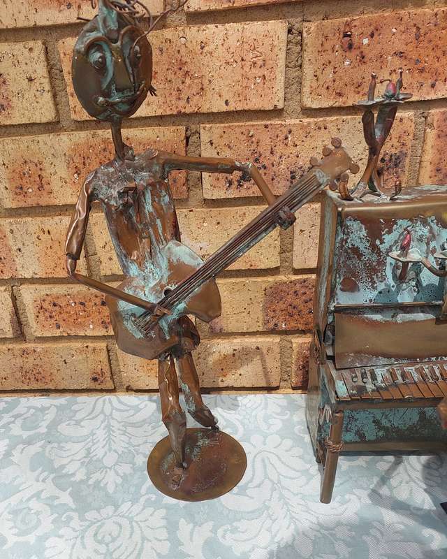 A COLLECTION OF COPPER FIGURINE ART SCULPTURES A PIANIST ,A PIANO WITH A SAXOPHONIST AND A BICYCLE
