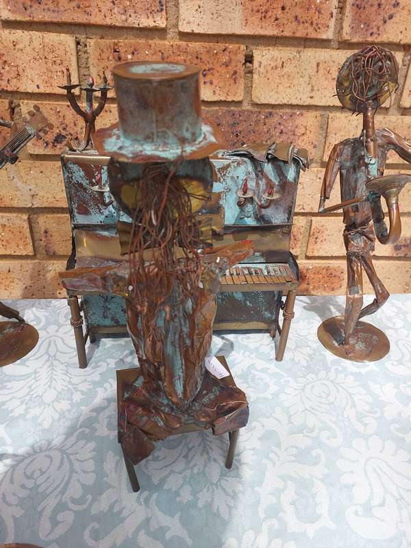 A COLLECTION OF COPPER FIGURINE ART SCULPTURES A PIANIST ,A PIANO WITH A SAXOPHONIST AND A BICYCLE