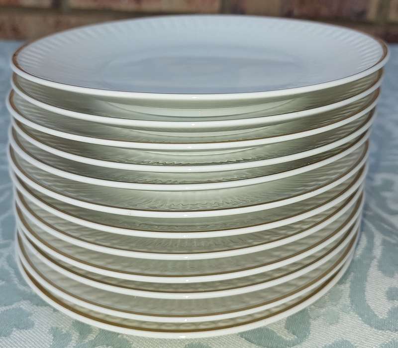 A VINTAGE SET OF 12 WHITE PORCELAIN AND GOLD TRIM SIDE PLATES