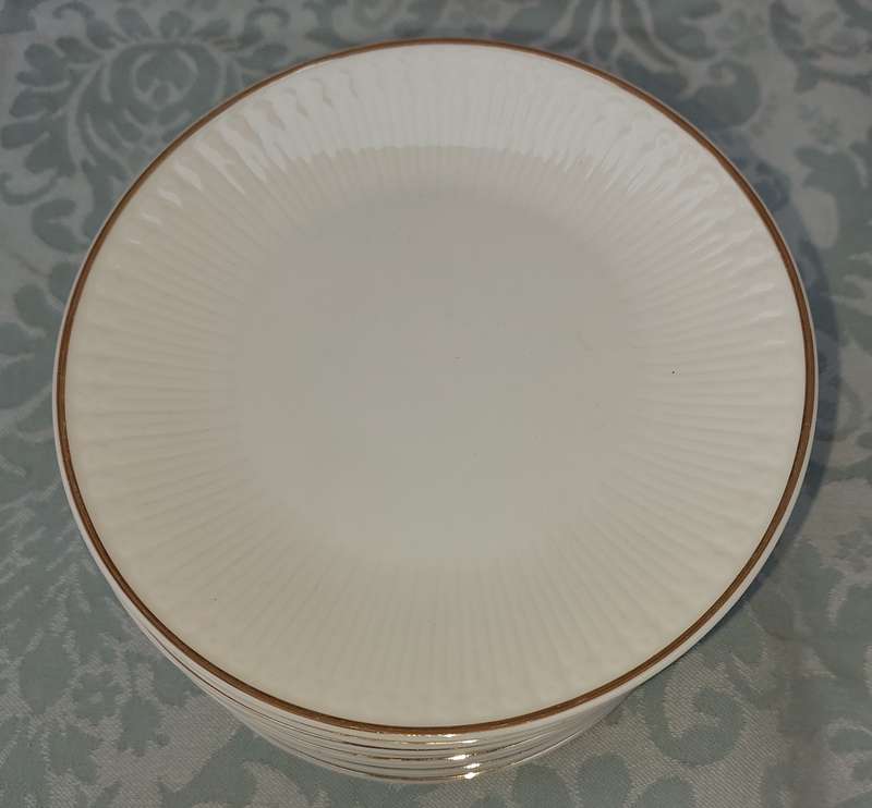 A VINTAGE SET OF 12 WHITE PORCELAIN AND GOLD TRIM SIDE PLATES