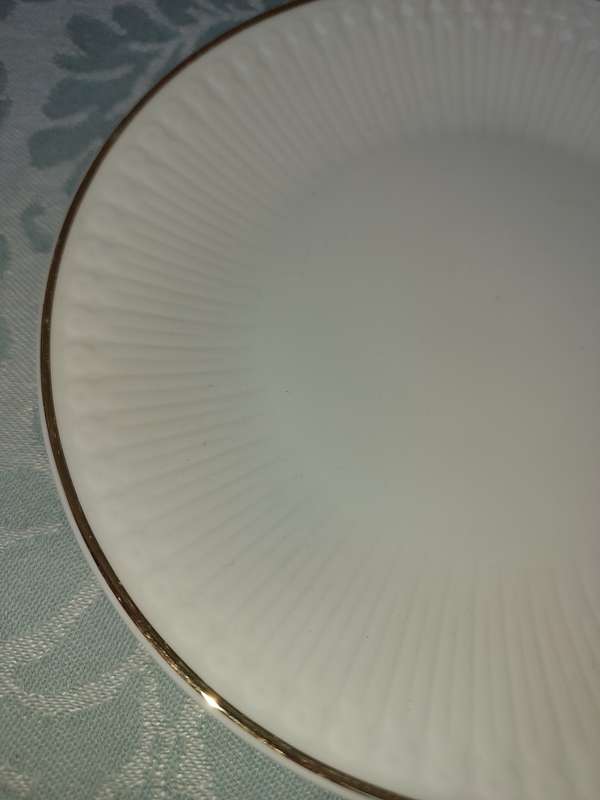 A VINTAGE SET OF 12 WHITE PORCELAIN AND GOLD TRIM SIDE PLATES