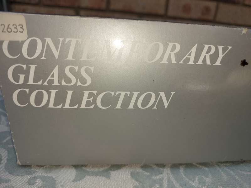 A CONTEMPORARY GLASS COLLECTION PORCELAIN SHELL WITH GOLD TRIM