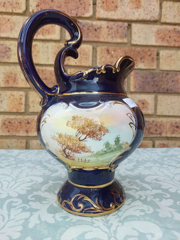 An art decor blue with gold trim and art work ceramic jug Roman style sold as is