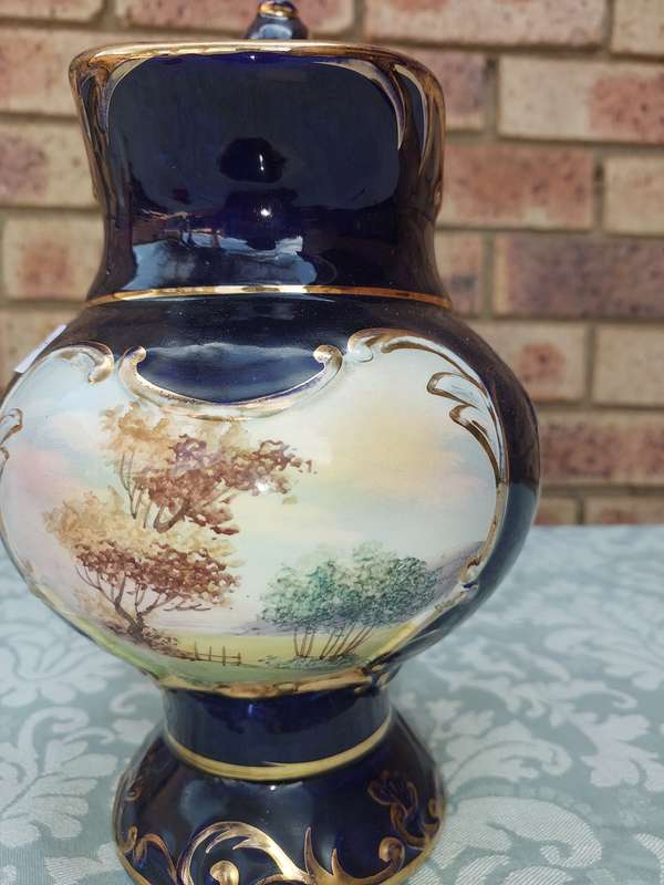 An art decor blue with gold trim and art work ceramic jug Roman style sold as is