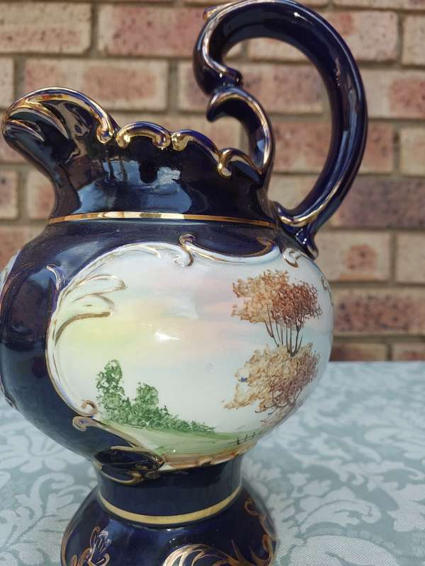 An art decor blue with gold trim and art work ceramic jug Roman style sold as is