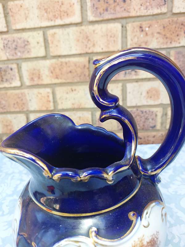 An art decor blue with gold trim and art work ceramic jug Roman style sold as is
