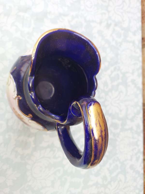 An art decor blue with gold trim and art work ceramic jug Roman style sold as is